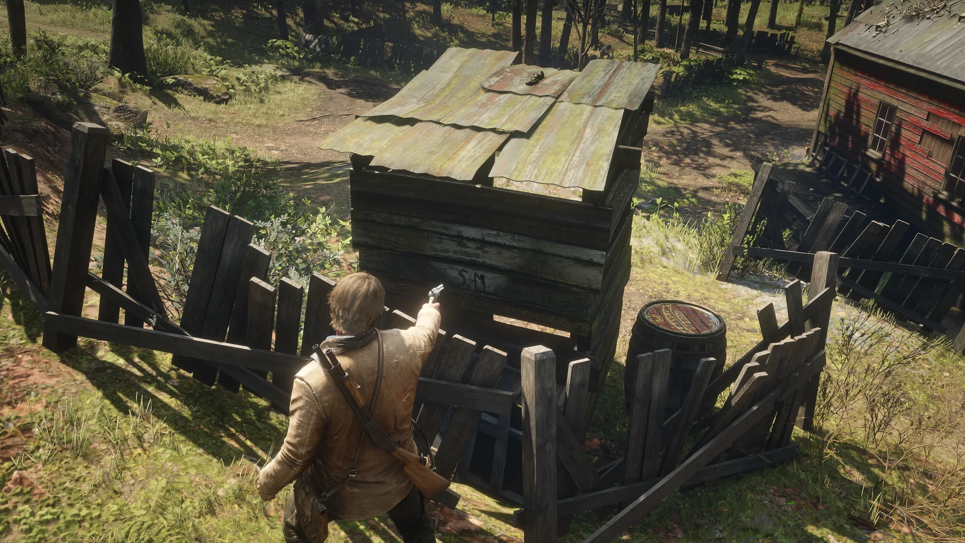 Arthur standing behind Outhouse 4 after shooting away the covering planks, revealing the hidden LJ and SM marks on the rear wall.